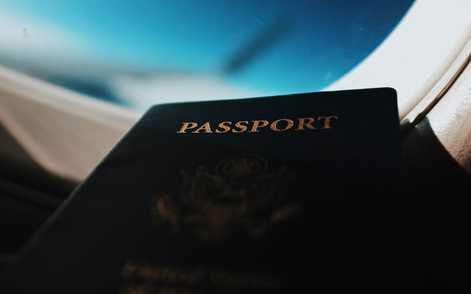 Passport infront of an airplane window