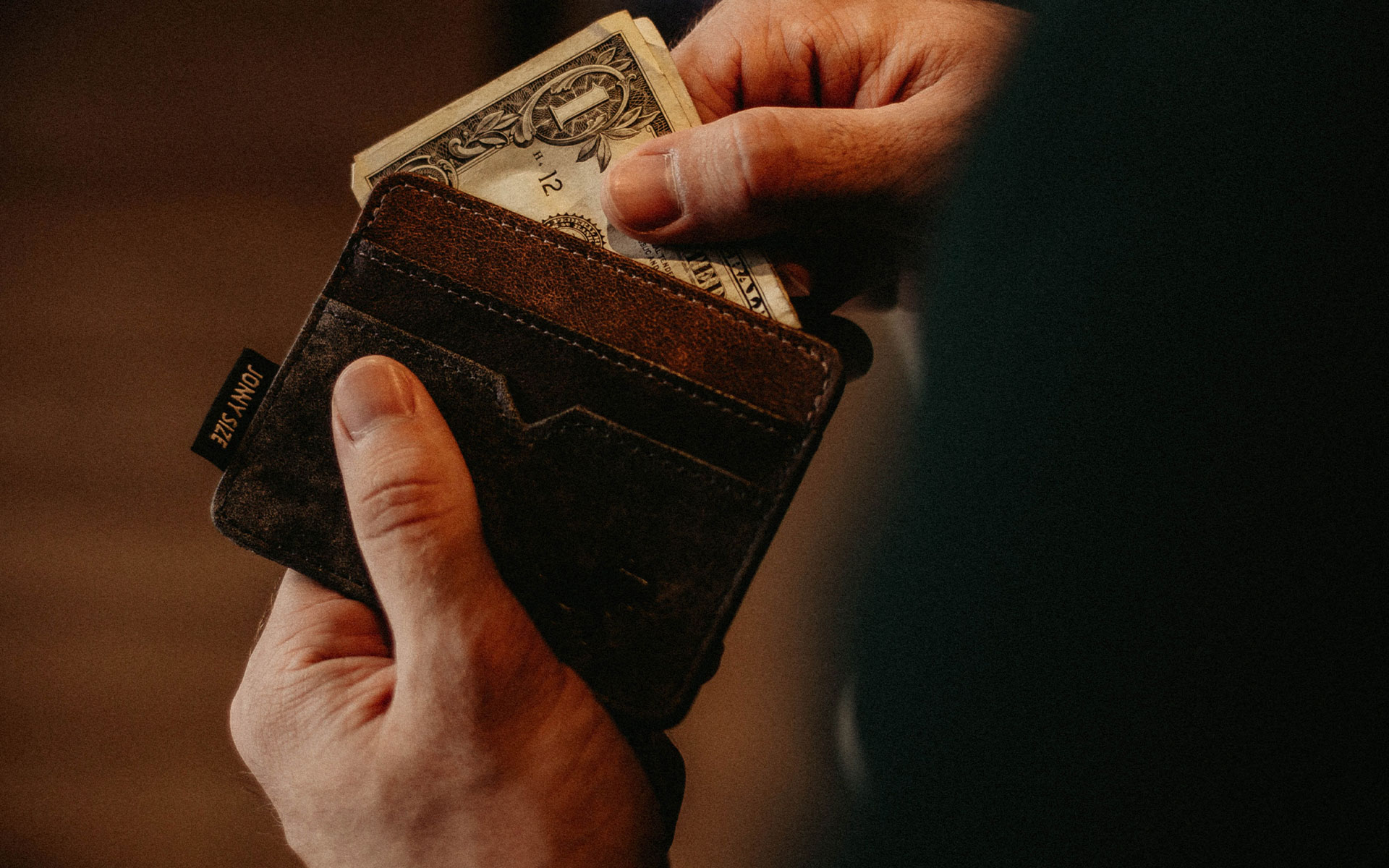 Man removing dollars from his wallet