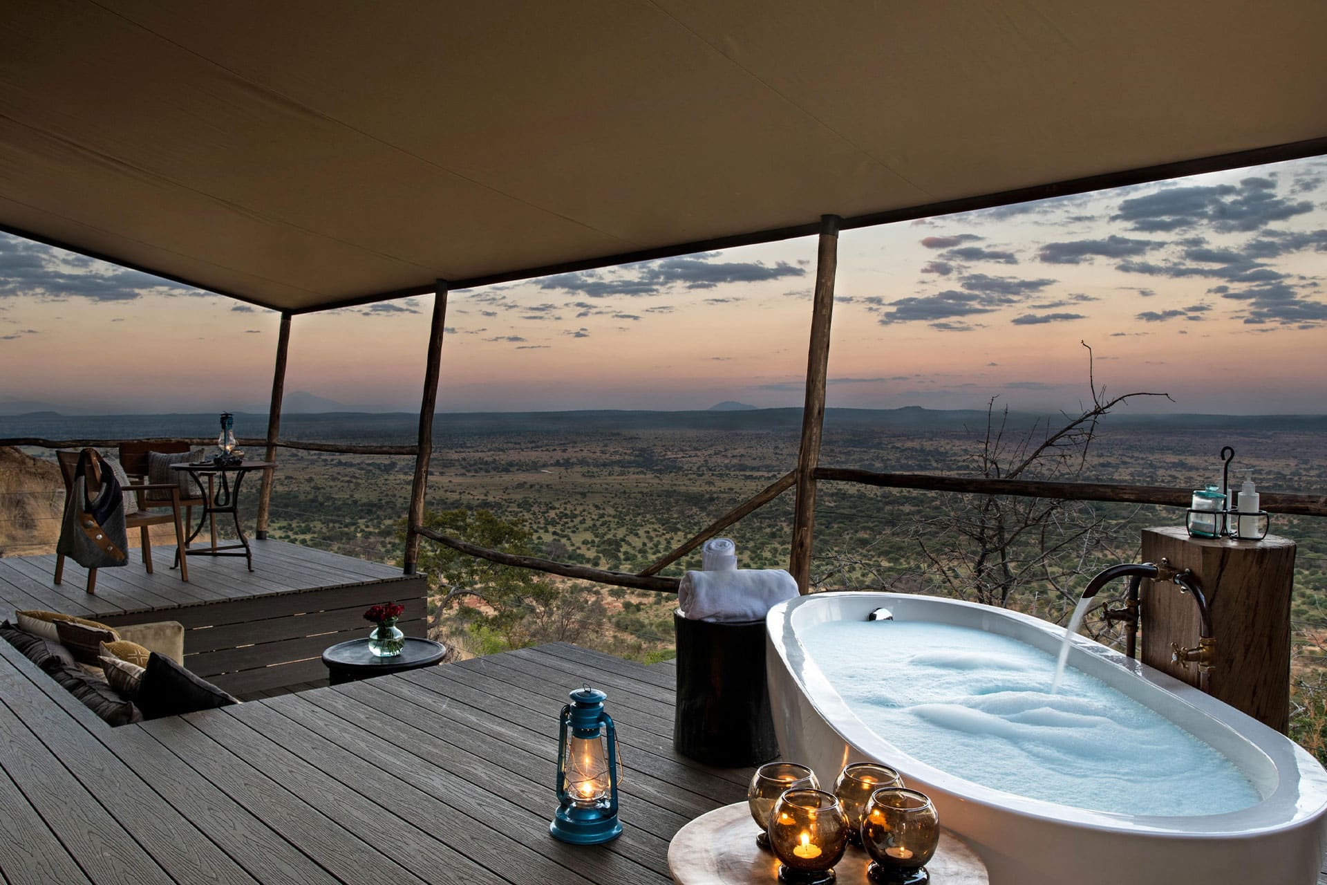 A luxury tent at Lemala Mpingo Ridge Lodge with a sunken lounge and outdoor bathtub overlooking the plains of Tarangire – a top choice for a slow safari in East Africa.