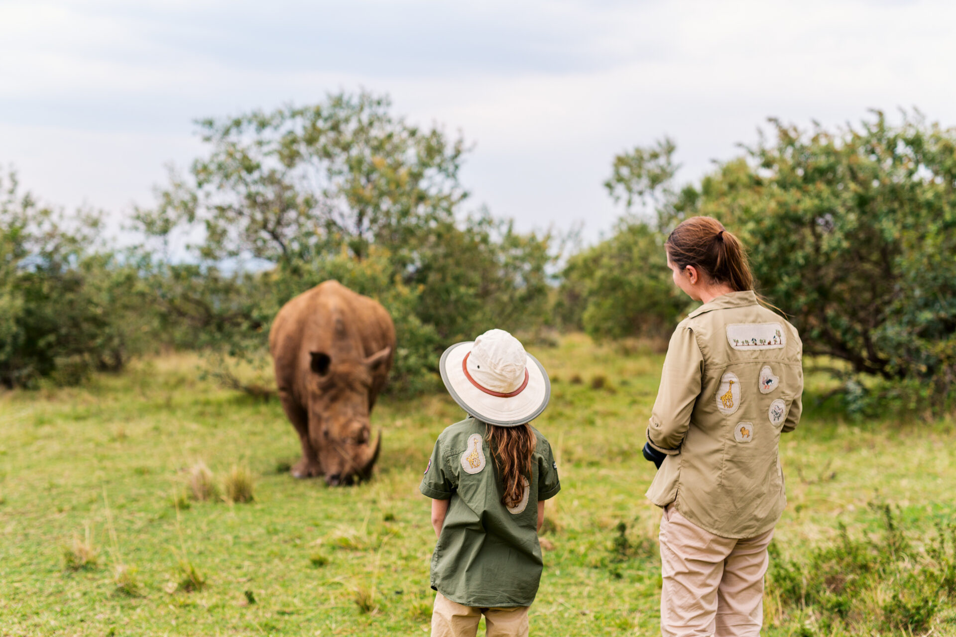 Child alongside expert conservationist - rhino conservation safaris are excellent eco safaris for kids.