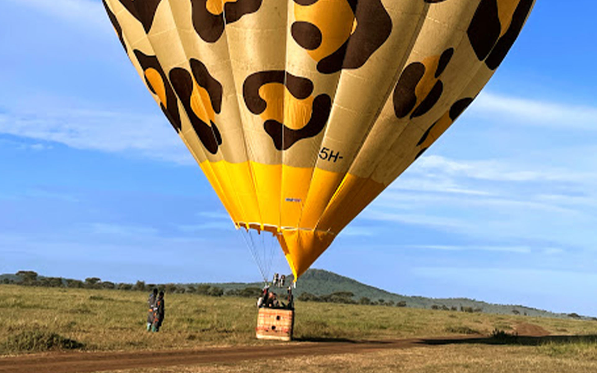 a leopard print ballooning with 2 springbok in the front over the Serengeti, Tanzania