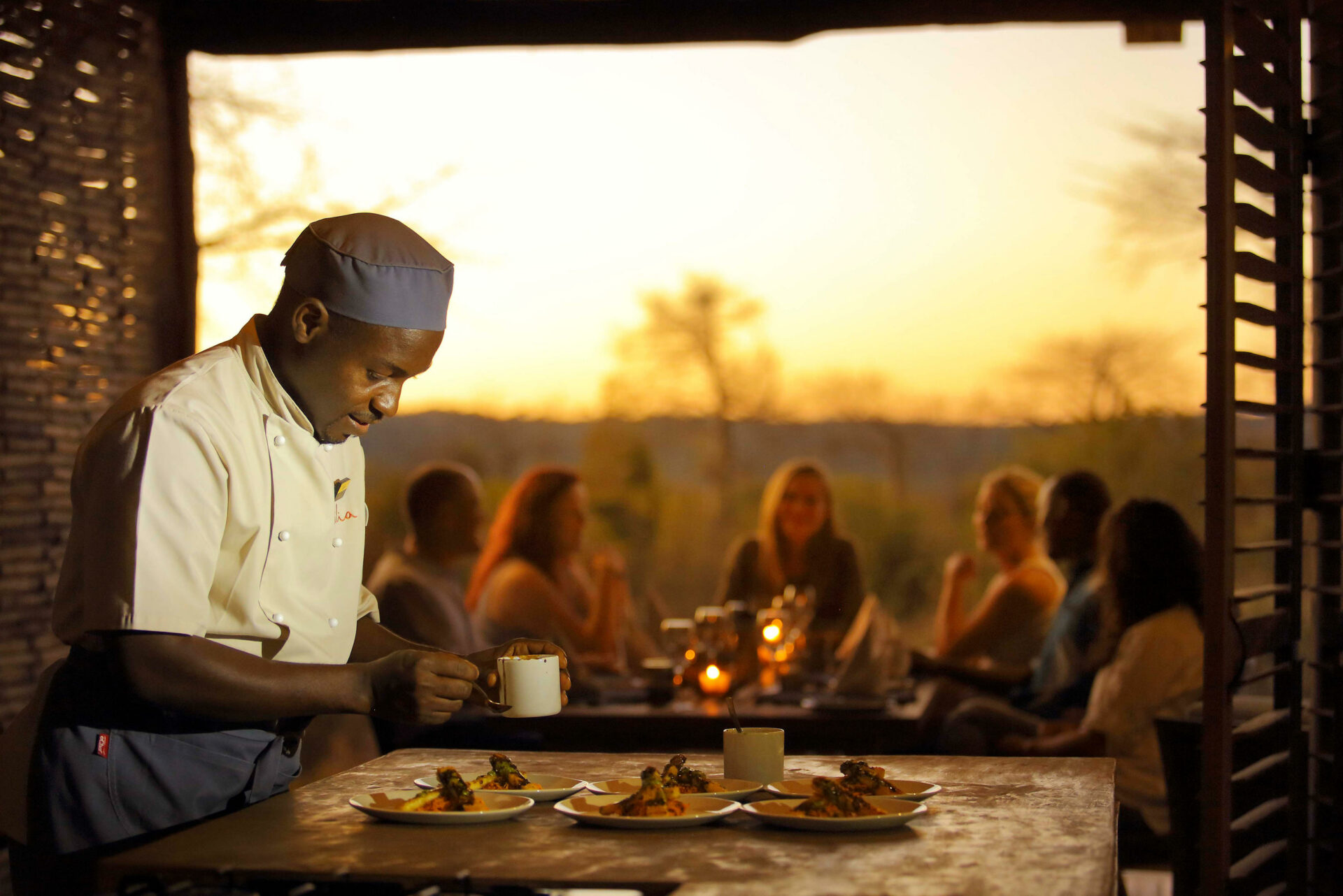 Jabali Private House with a private chef and a guests in the background, with Grand Africa Safaris